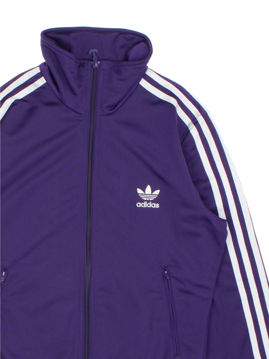 Vintage Adidas Tracksuit Jacket in a purple and silver colourway. Zips up and has side pockets, the iconic three stripes going down the arms, and has the logo embroidered on the front and printed on the back.