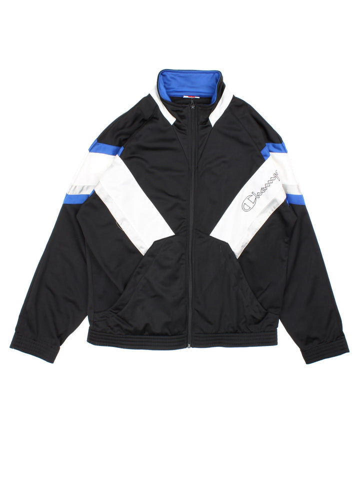 Vintage Champion Tracksuit Jacket in a black, white and blue patterned colourway. Zips up and has side pockets, and has the logo spell out embroidered on the front and on the back.