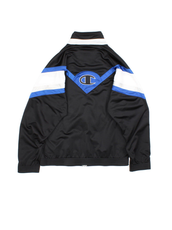 Vintage Champion Tracksuit Jacket in a black, white and blue patterned colourway. Zips up and has side pockets, and has the logo spell out embroidered on the front and on the back.