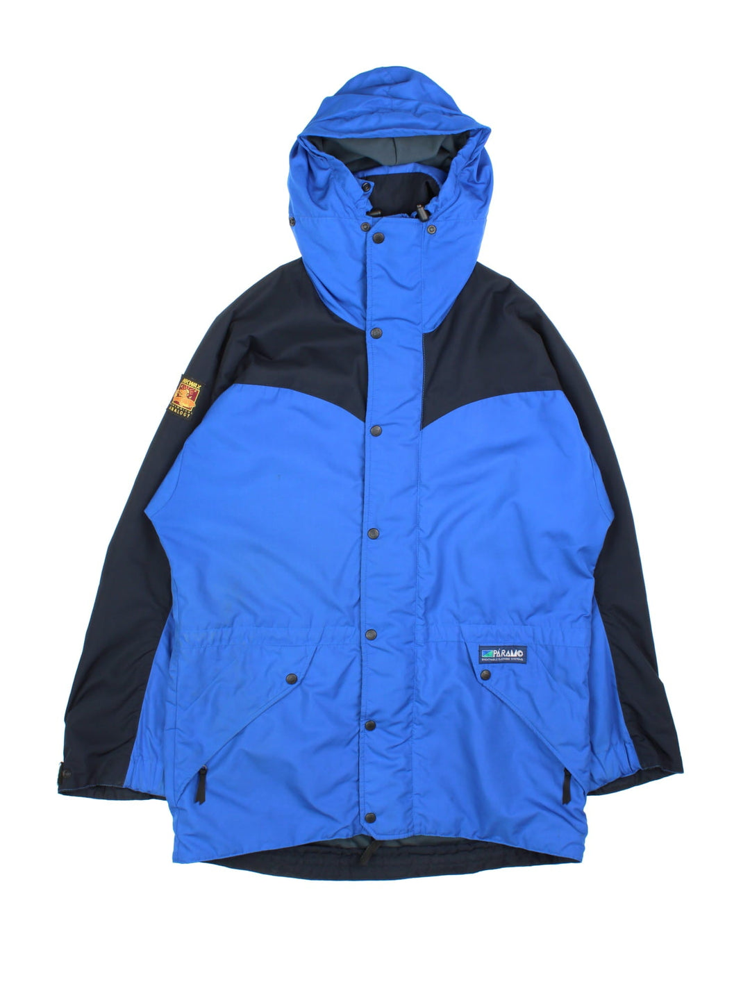 Vintage Paramo Nikwax Jacket in a blue and black colourway. Zips and buttons up, has side pockets, insulated lining, hooded, and has the logo embroidered on the front amd on the right sleeve.