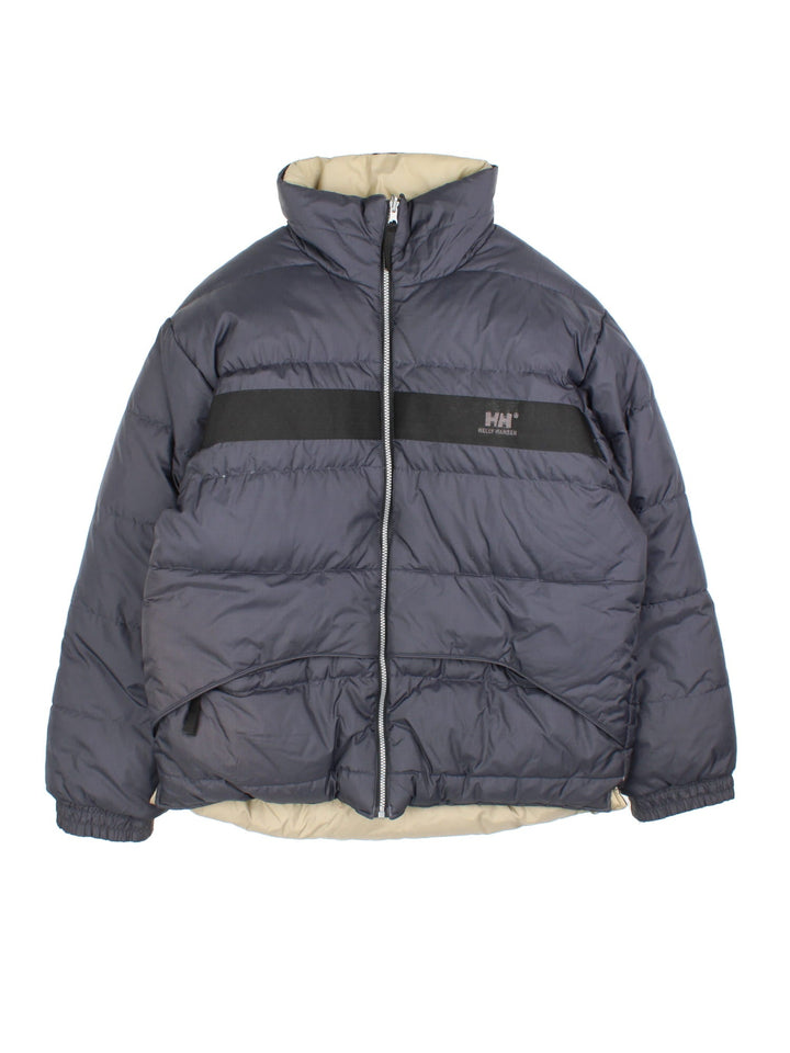 Vintage Helly Hansen Reversible Puffer Coat in either a black or beige colourway options. Zips up and has side pockets, insulated lining, and has the logo embroidered on the front and back.