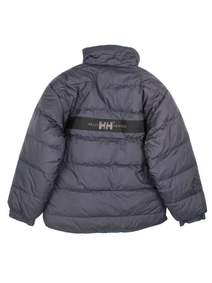 Vintage Helly Hansen Reversible Puffer Coat in either a black or beige colourway options. Zips up and has side pockets, insulated lining, and has the logo embroidered on the front and back.