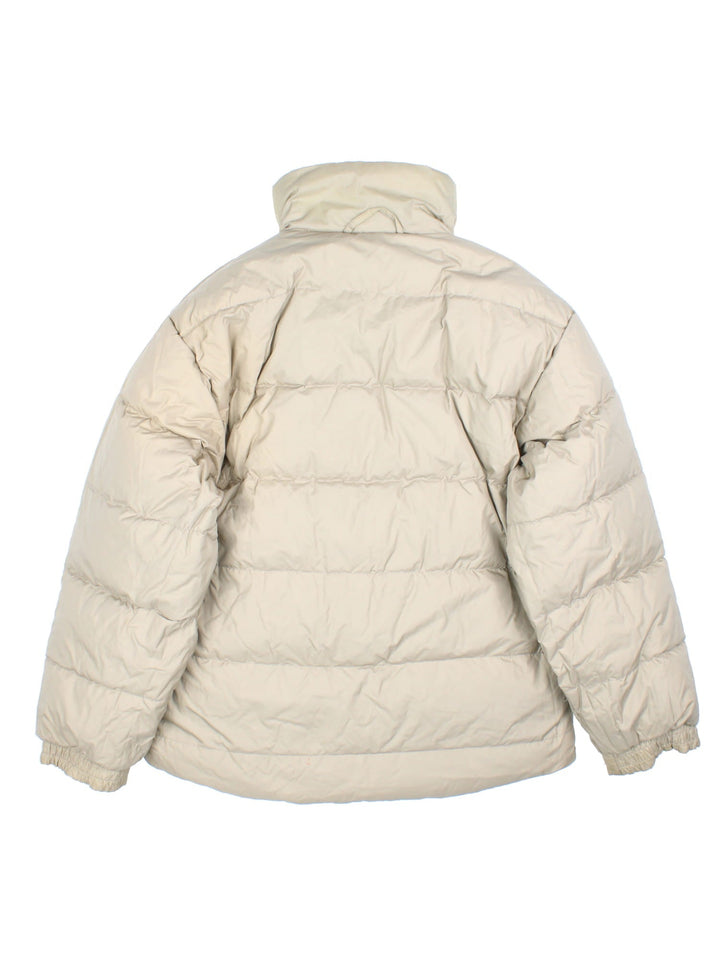 Vintage Helly Hansen Reversible Puffer Coat in either a black or beige colourway options. Zips up and has side pockets, insulated lining, and has the logo embroidered on the front and back.