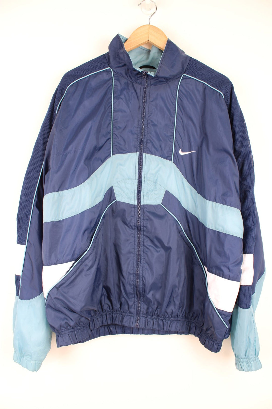 Vintage 90s Nike tracksuit top with blue and white panelling details and embroidered logo on the front and back.