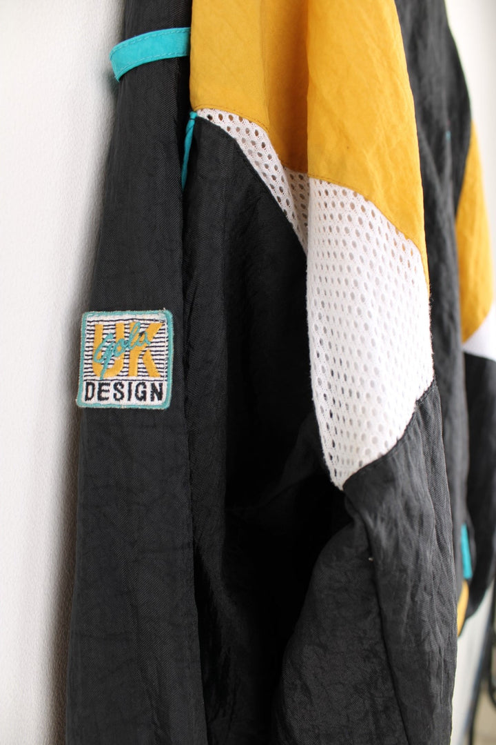 Vintage Gola tracksuit top in black and yellow with embroidered logo on the chest.