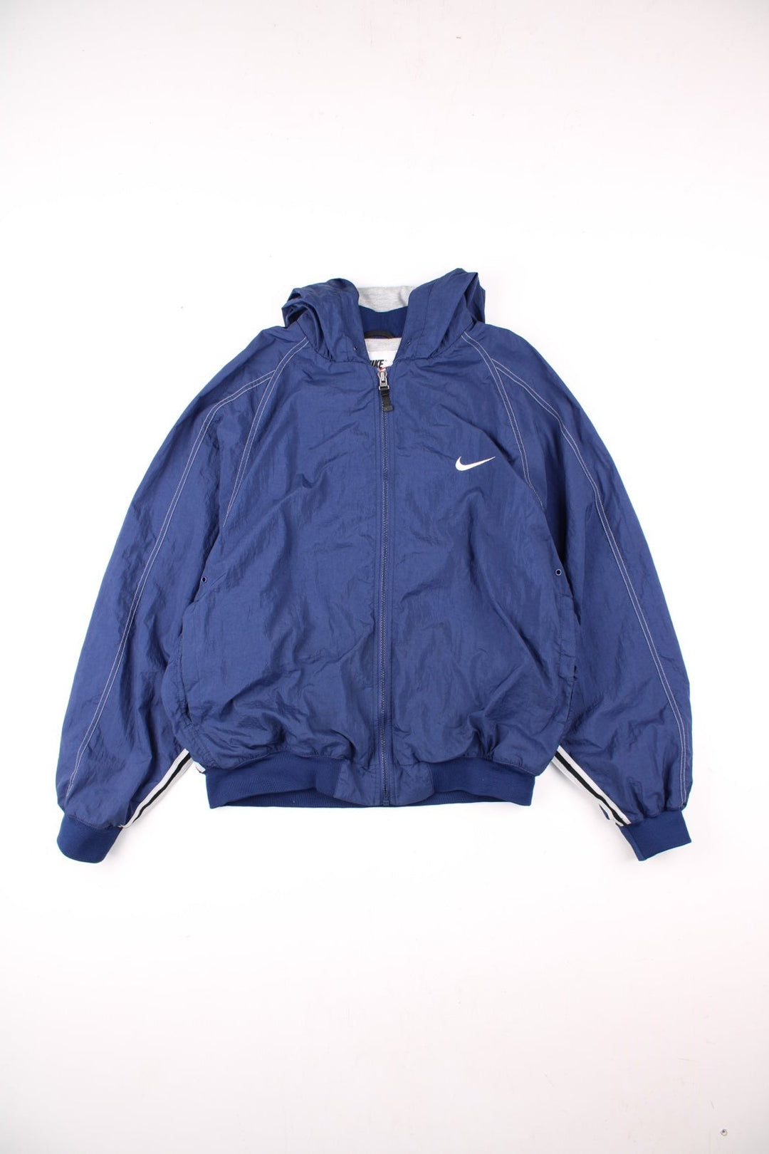 Vintage 90's Nike Lightweight Jacket in navy blue with cross stitching around, has two pockets, zip closure, hooded, and the swoosh logo embroidered on the chest.