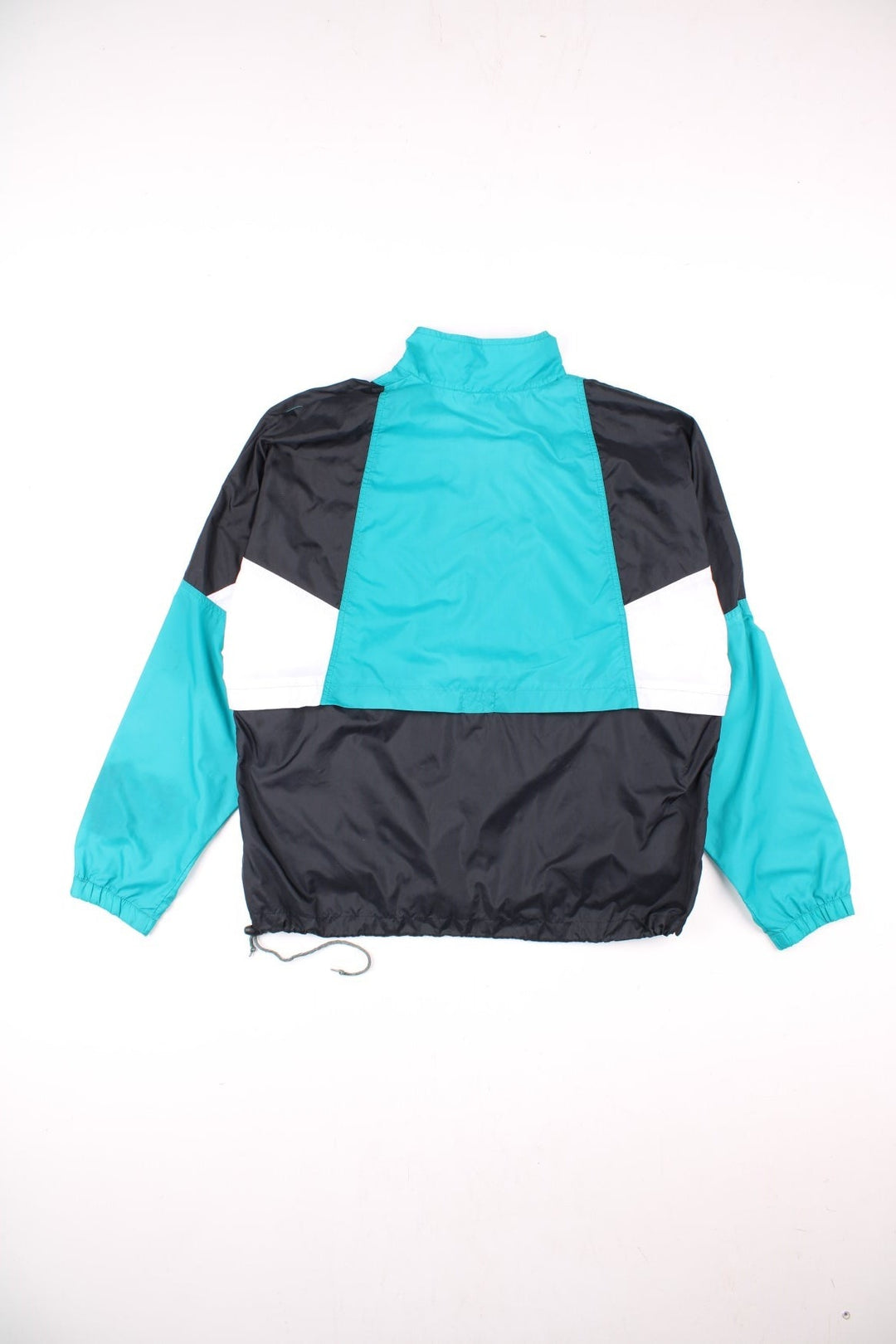 Vintage 90's Nike Pullover Windbreaker in black, with turquoise and white panelling, two pockets, half zip closure, and an embroidered logo on the chest.