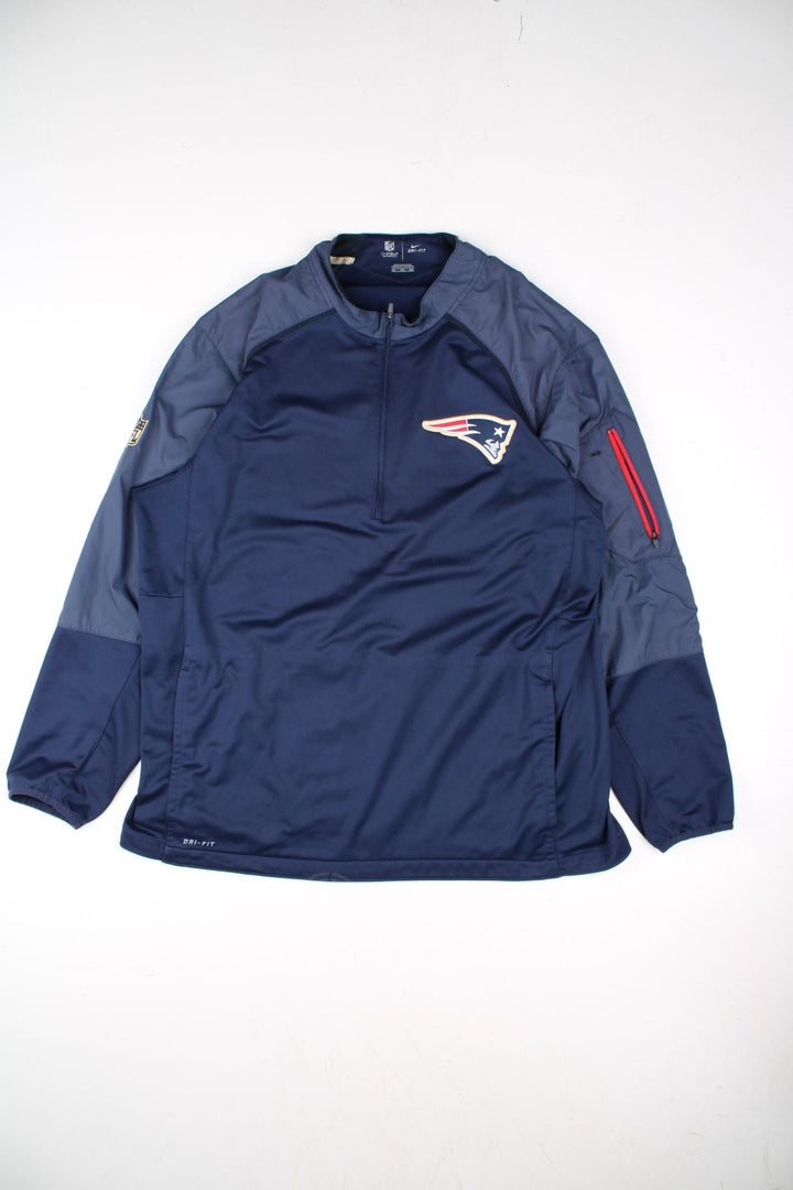 Nike New England Patriots NFL Track Top in a blue colourway.1/4 zip with large club logo on the chest.