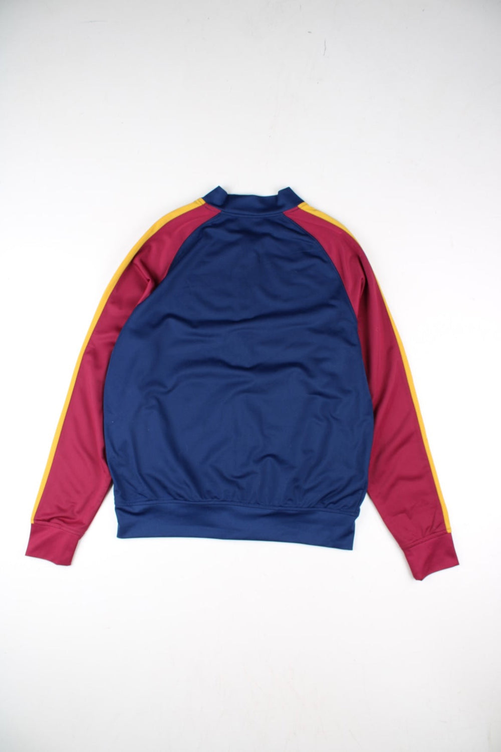 Umbro Barcelona Track Top in a blue colourway with red panelling and yellow stripe. Full zip with small club and brand logos on the front..