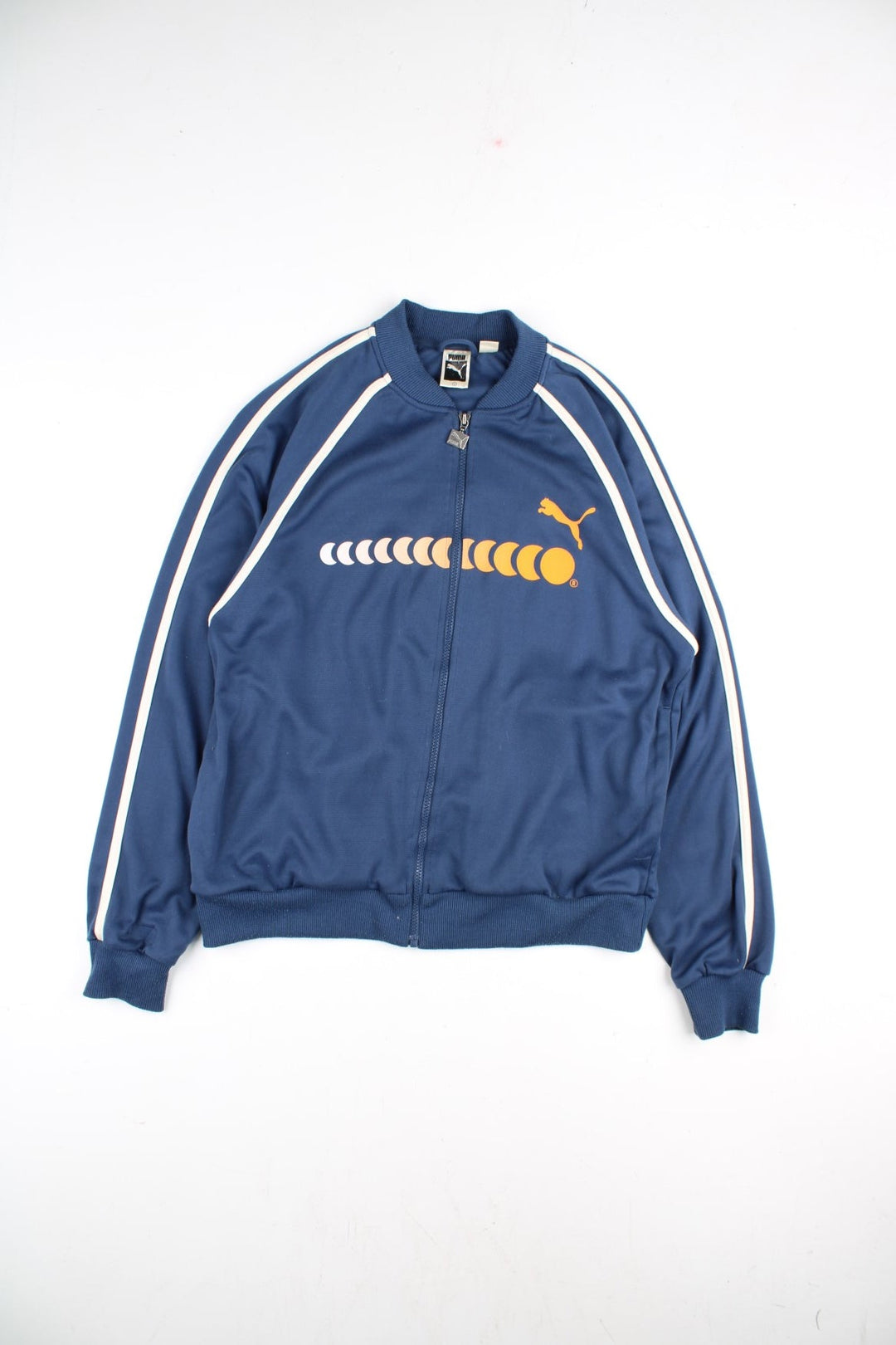 90's Puma Track Top in a blue colourway with yellow logo across the chest. White stripe along the sleeves and front with a full zip.