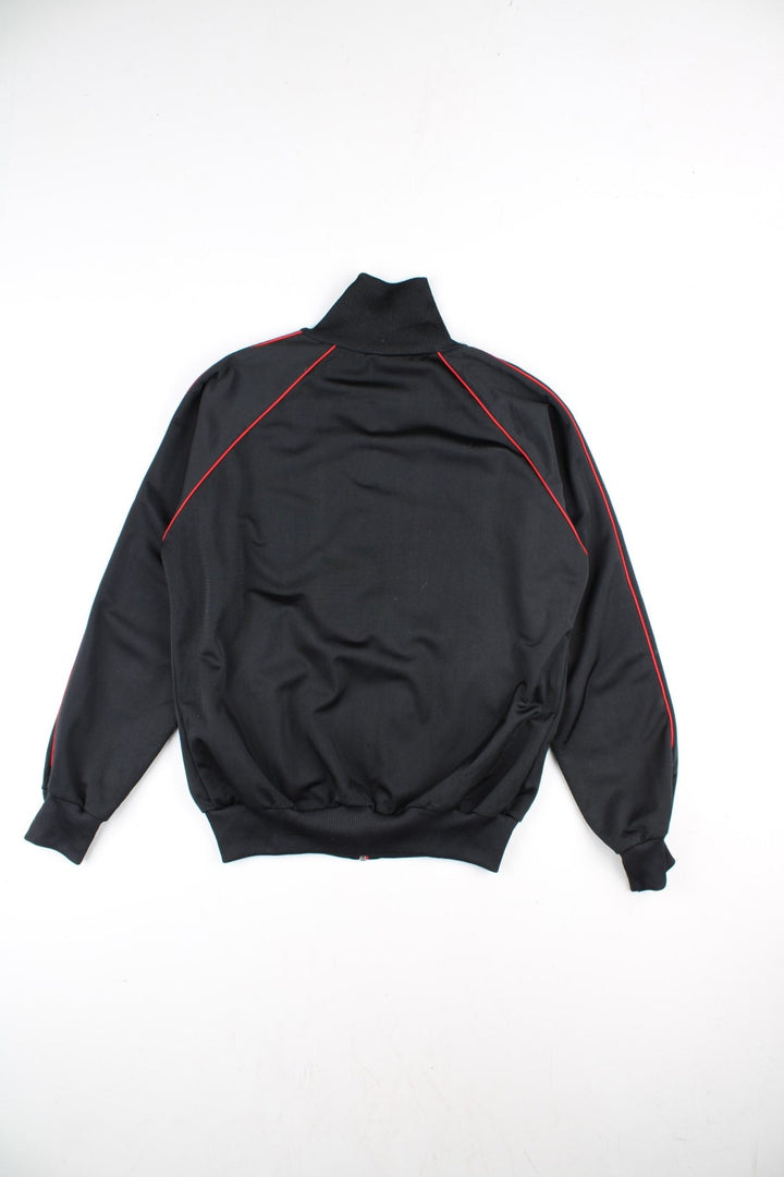 Puma Track Top in a black colourway with a red full zip and stripe. Small Puma logo on the chest