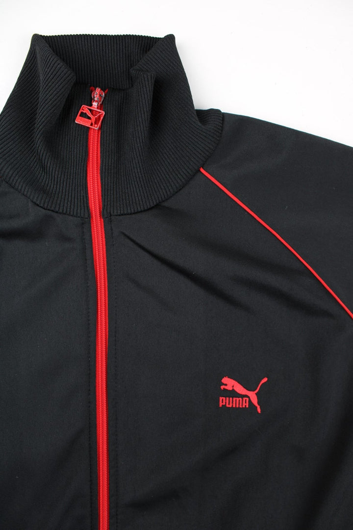 Puma Track Top in a black colourway with a red full zip and stripe. Small Puma logo on the chest