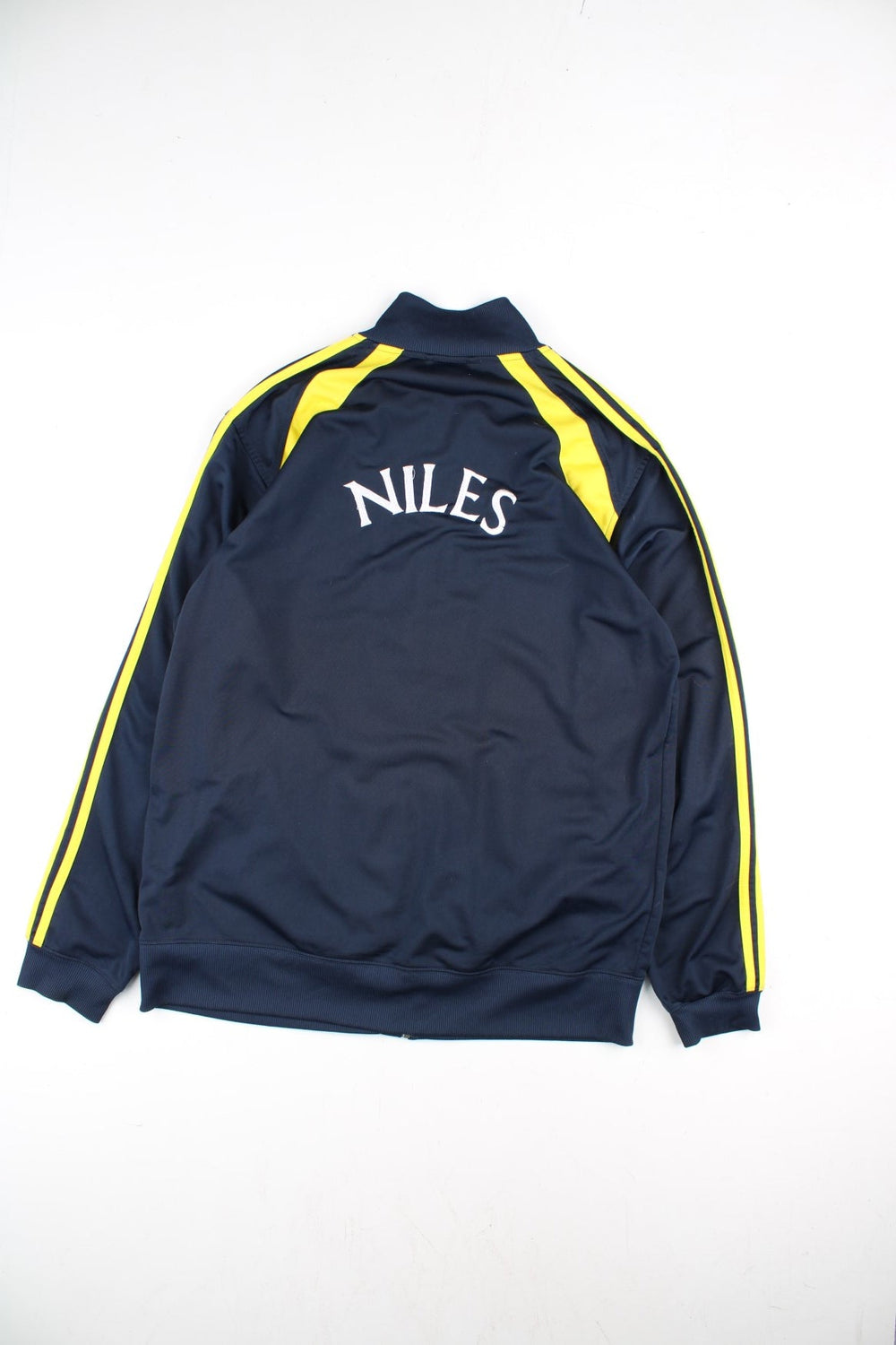 Adidas Track Top in a blue colourway with yellow 3 striple and panelling. Full zip and pockets on the front with NILES lettering on the back.