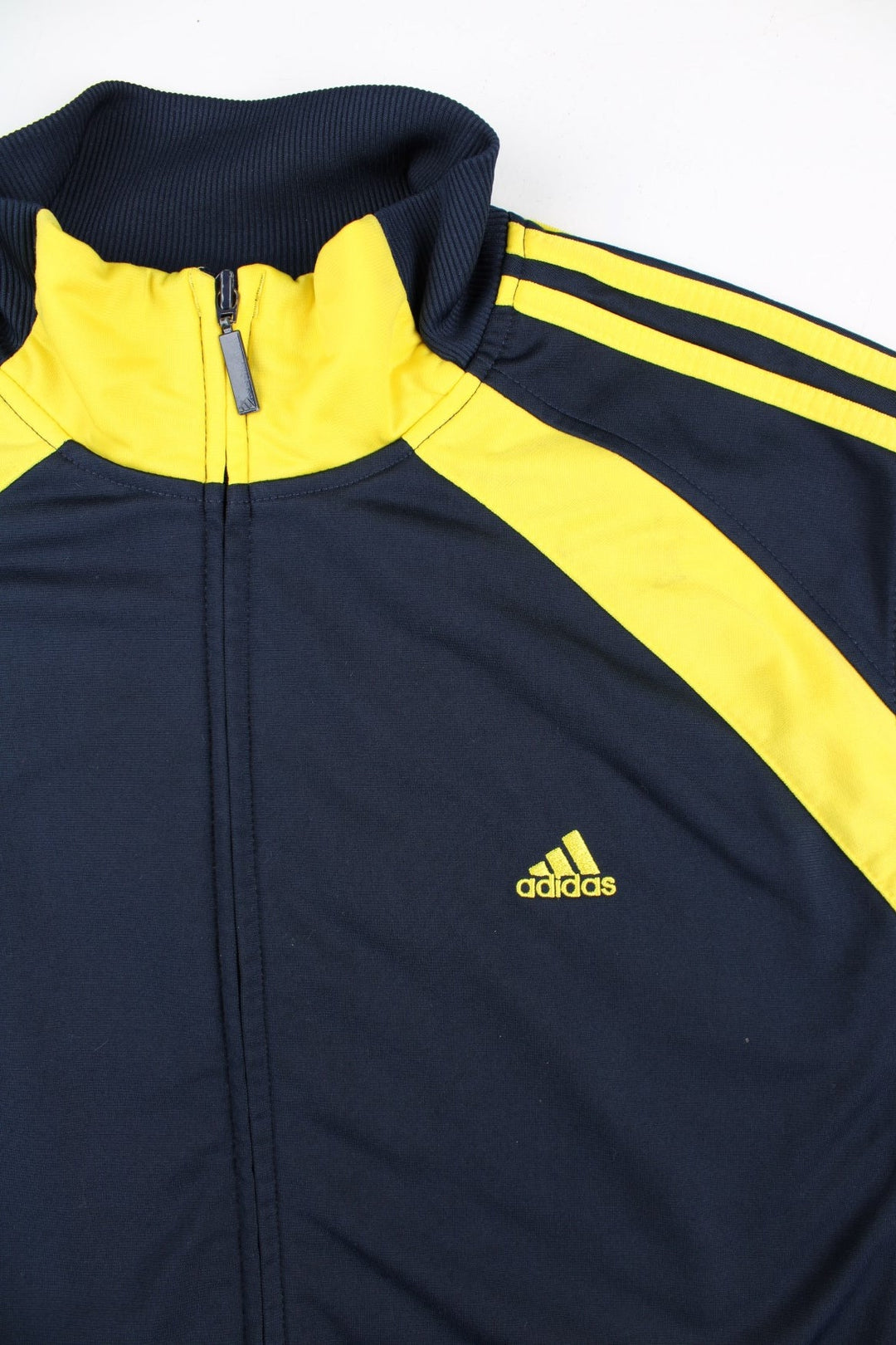 Adidas Track Top in a blue colourway with yellow 3 striple and panelling. Full zip and pockets on the front with NILES lettering on the back.