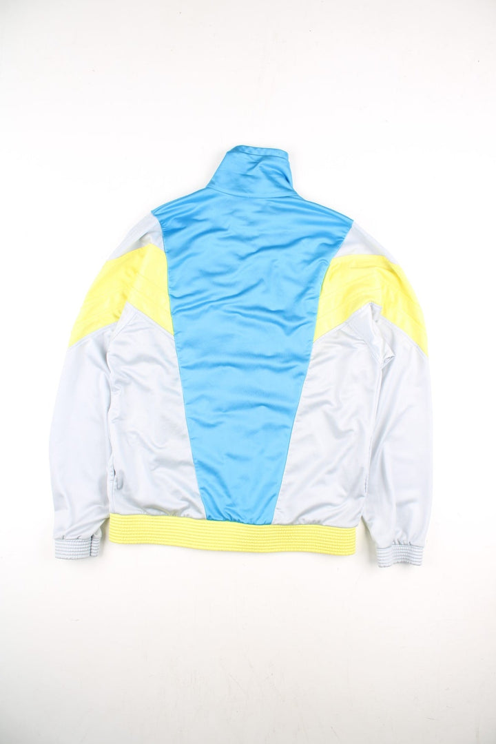 Le Coq Sportif Track Top in a grey colourway with blue and yellow panelling.Full zip with two side pockets. Buttons up and has side pockets.