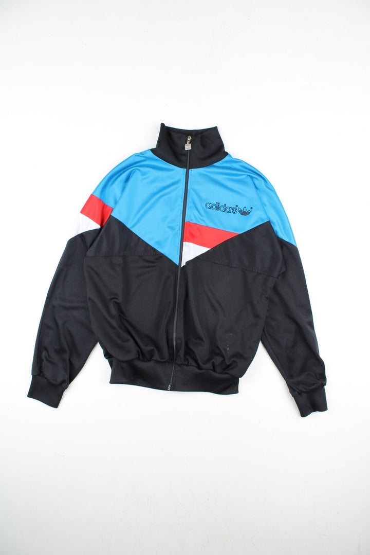 Vintage Adidas Track Top in a black colourway with blue top half panelling and small classic logo on the front with a full zip