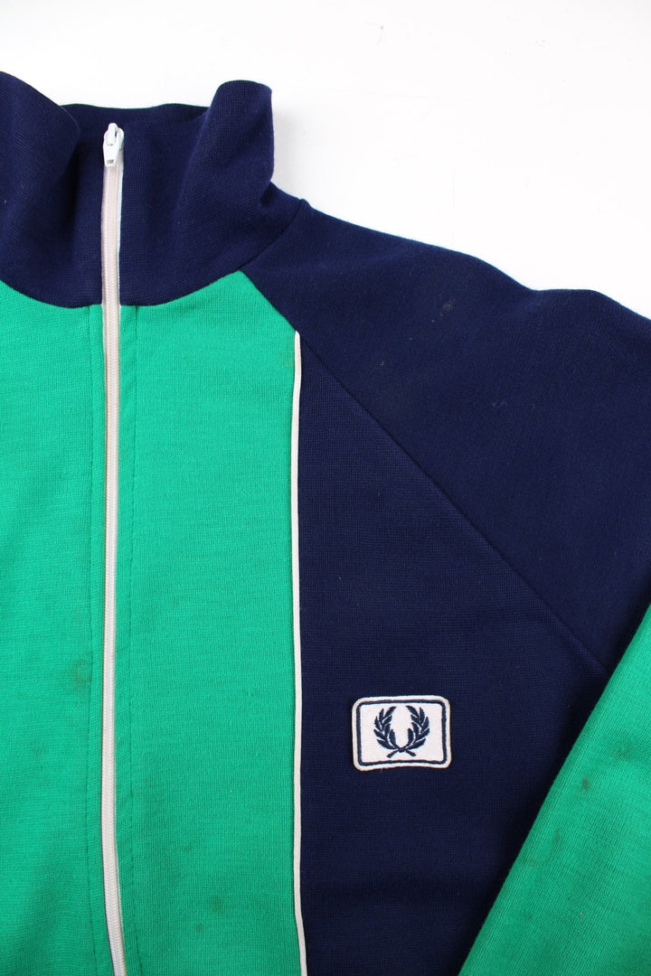 Vintage Fred Perry Track Top in a blue colourway with green panelling. Full zip design and small embroidered logo on the front.