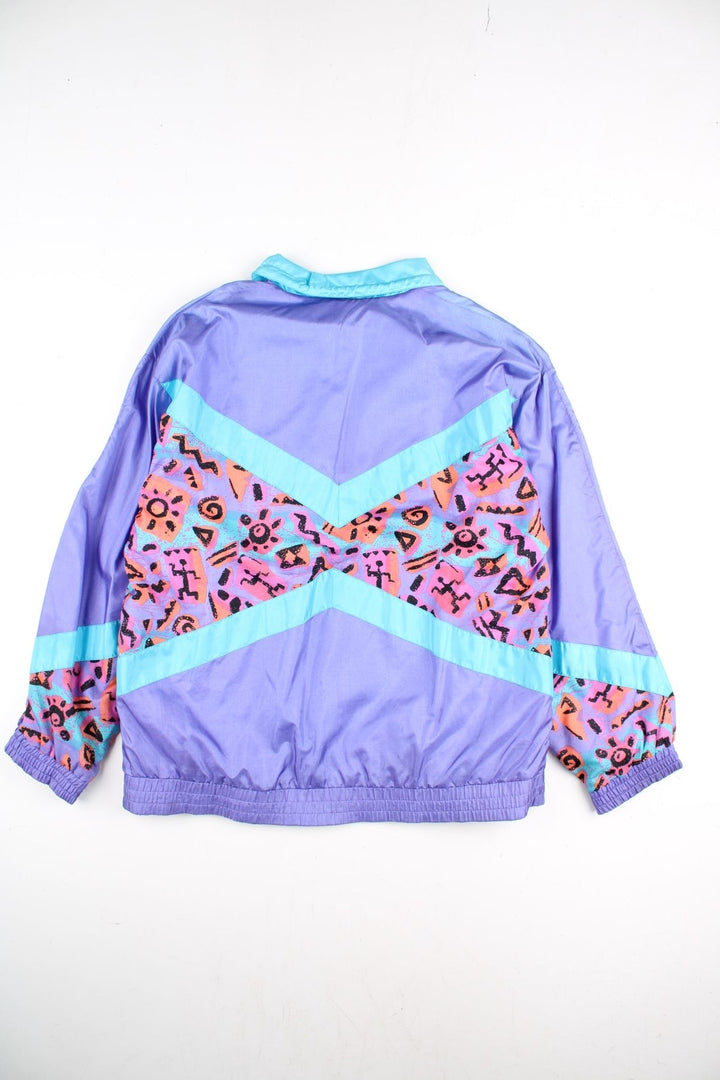 Vintage Adidas 90's Track Top in a purple colourway with blue stripe panelling and retro pattern across the front and back. Full zip and side pockets with small classic logo on the front