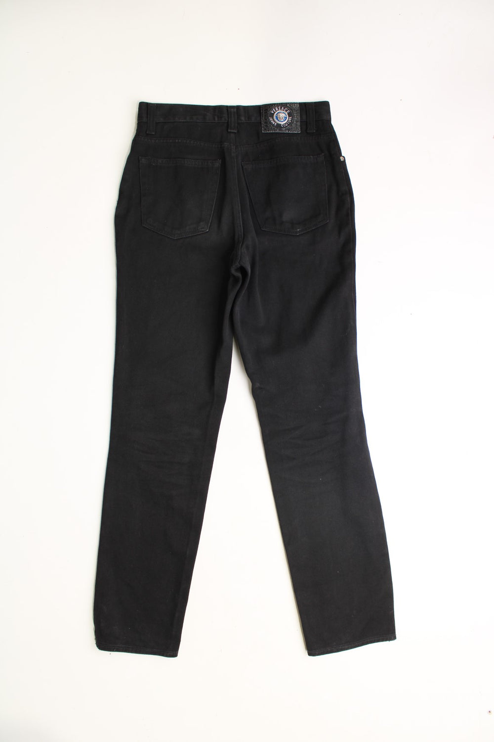 Vintage Versace all black high-waisted jeans, features branded hardware and signature branded leather patch on the waistband 