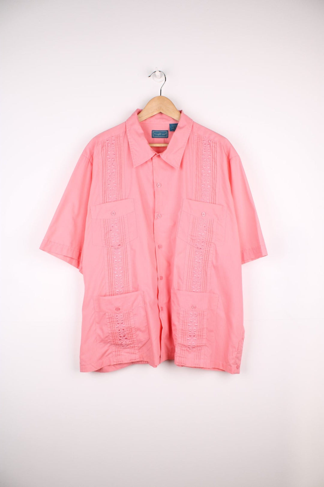 Pale pink Hawaiian-inspired embroidered short sleeved shirt by Tropicool, with buttons and four pockets. 