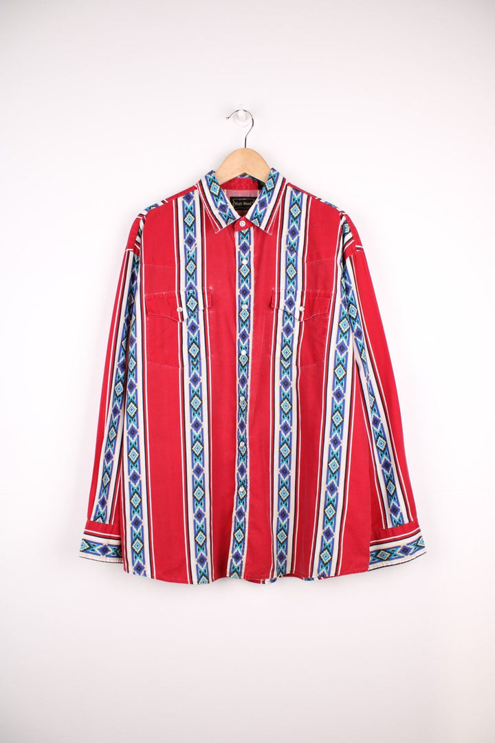 Patterned red and blue western shirt by High Noon with pearl-effect snap closure and two flap pockets. 