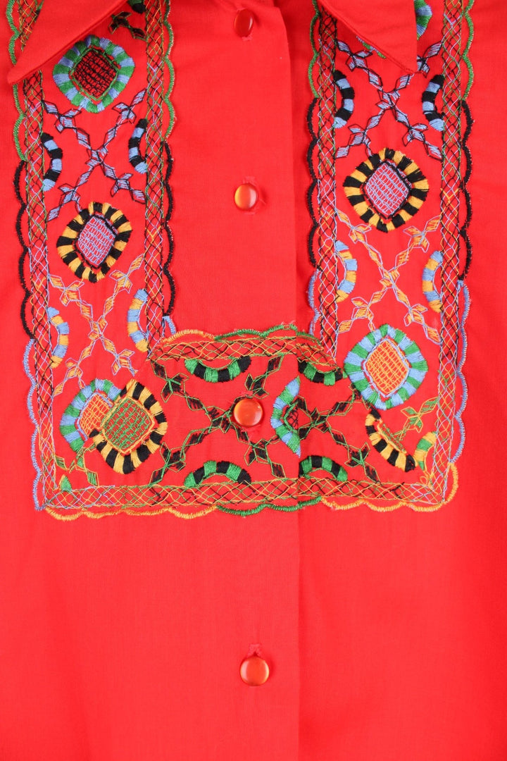 Red western blouse with a floral embroidered yoke and sleeves. 