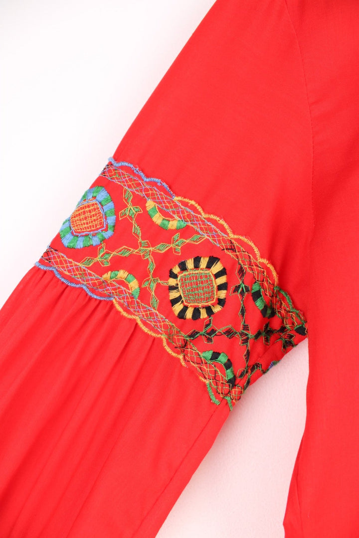 Red western blouse with a floral embroidered yoke and sleeves. 