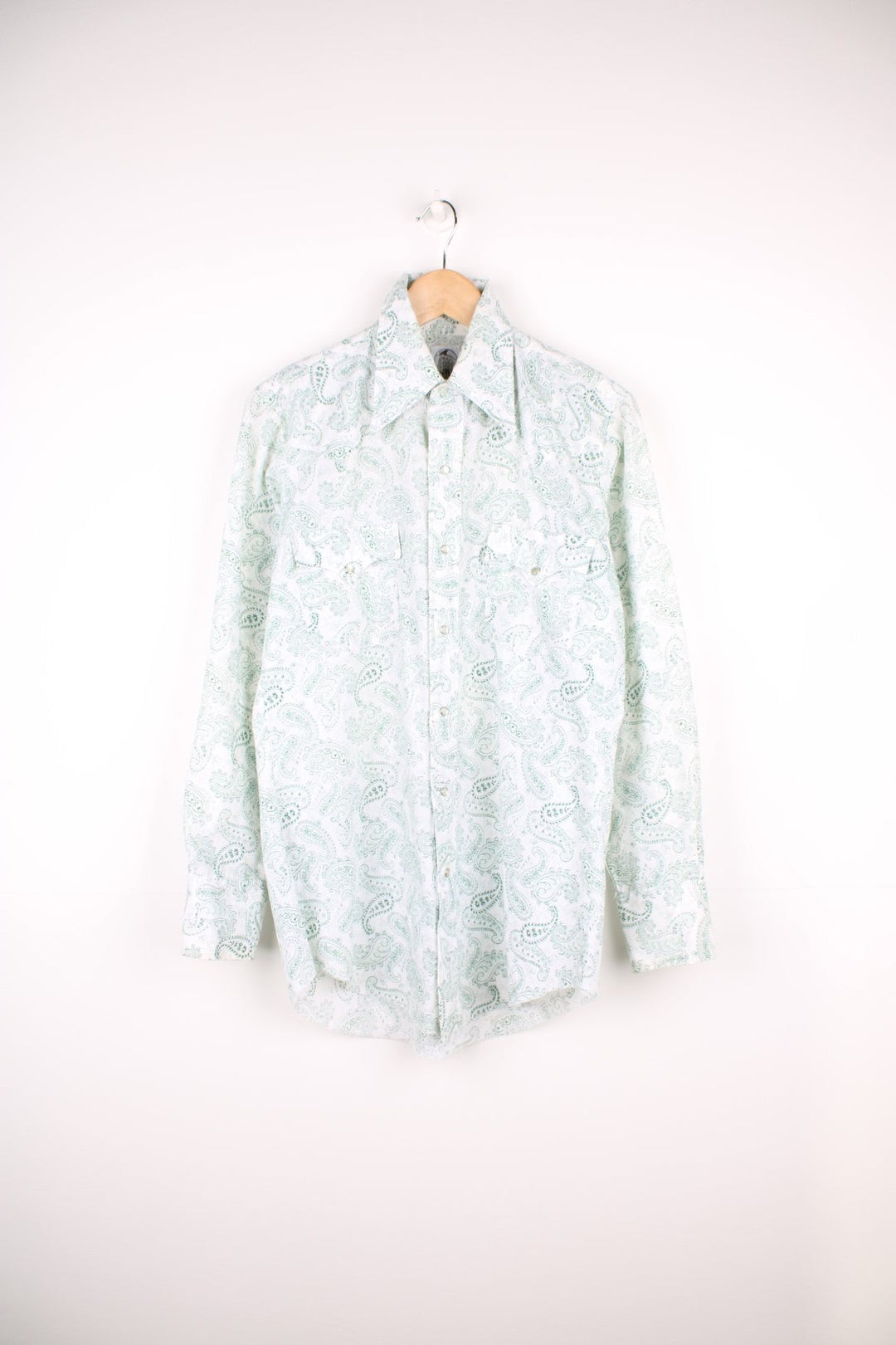 Green paisley patterned western shirt by The Hustler Collection - dagger-collared, with two flap pockets and pearl-effect snap closure. 