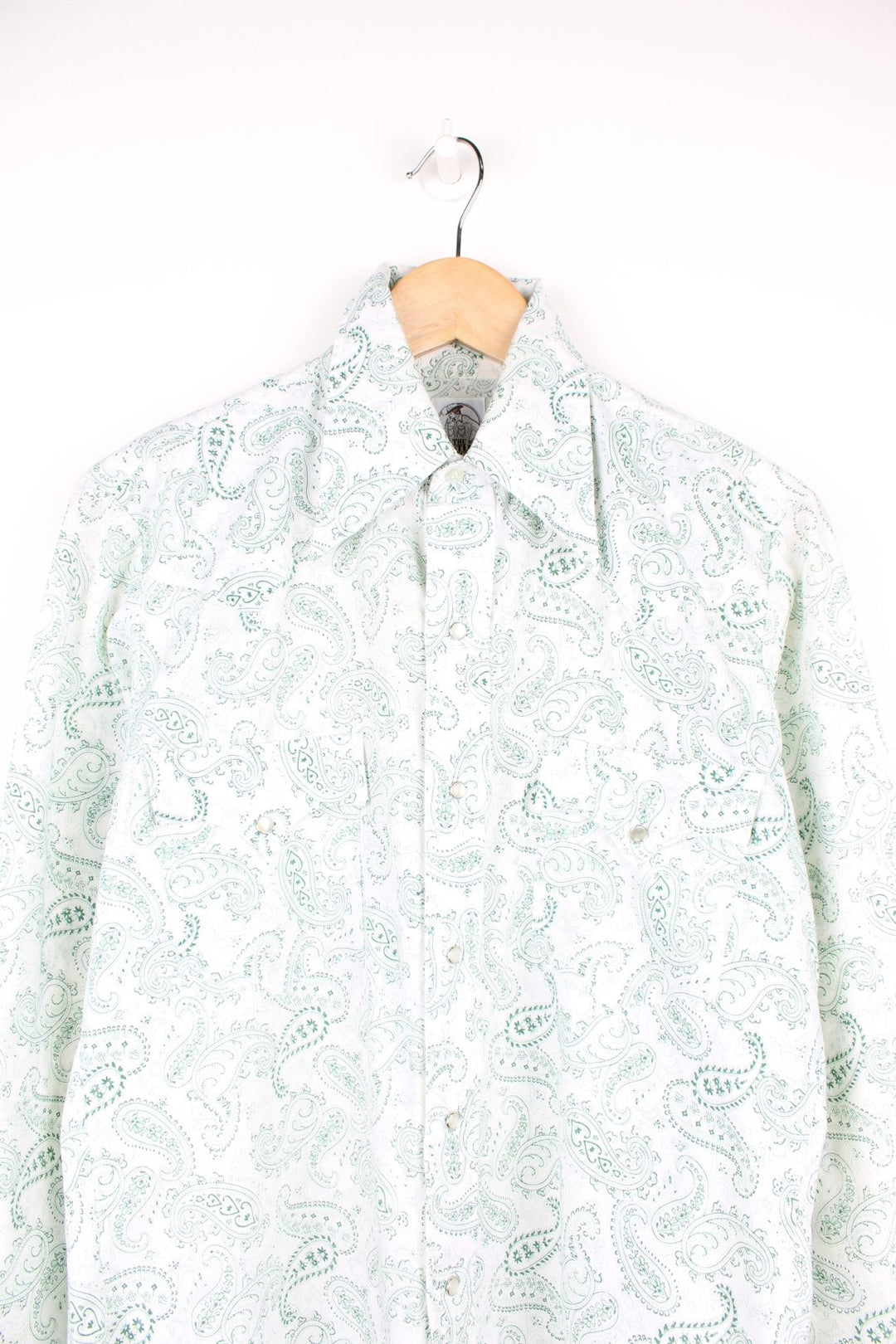 Green paisley patterned western shirt by The Hustler Collection - dagger-collared, with two flap pockets and pearl-effect snap closure. 