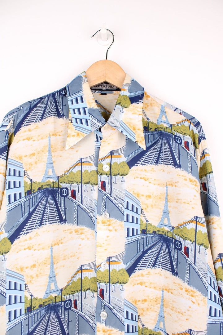 Dagger-collared shirt by Master Built with repeating pattern of a train station and the Eiffel tower. 