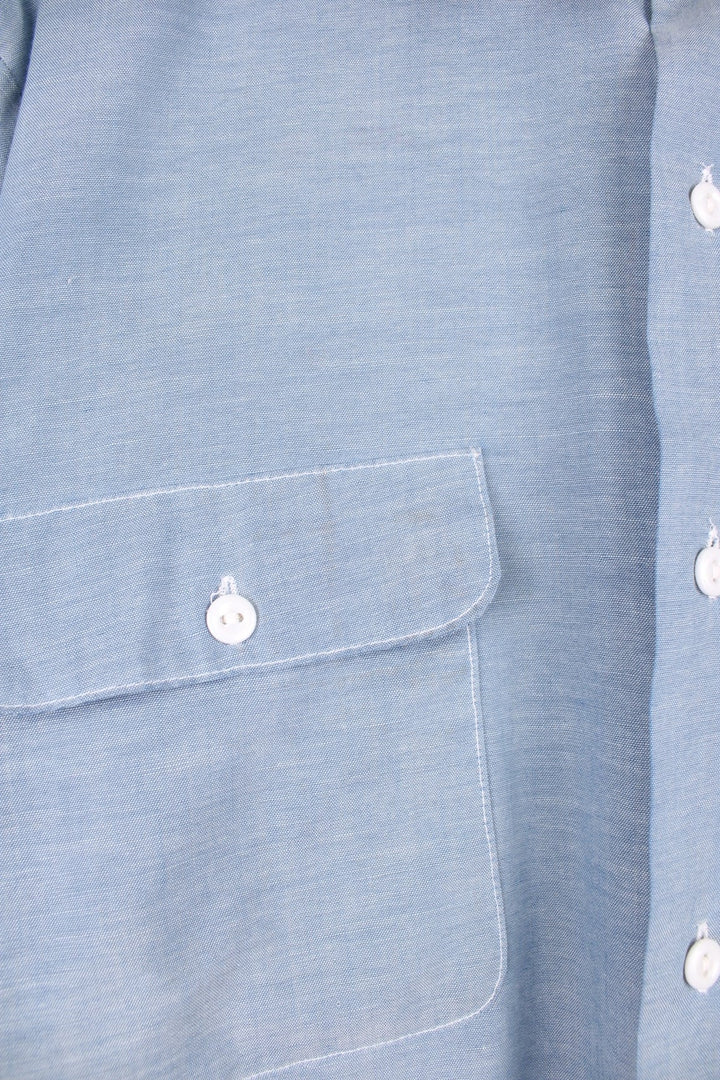 Grey western shirt with colourful embroidery on the front and back, with two flap pockets. 