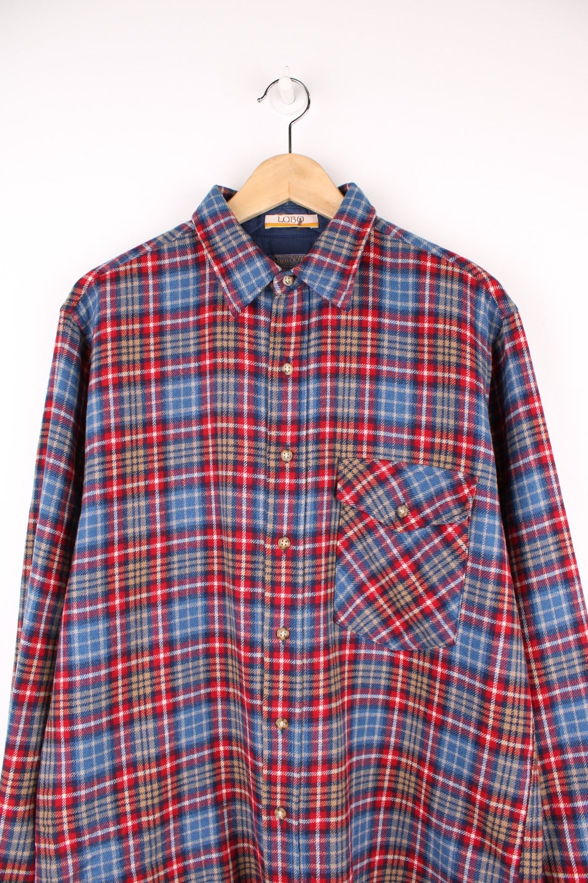 Blue and red plaid Pendleton shirt, 100% wool with one buttoned flap pocket.