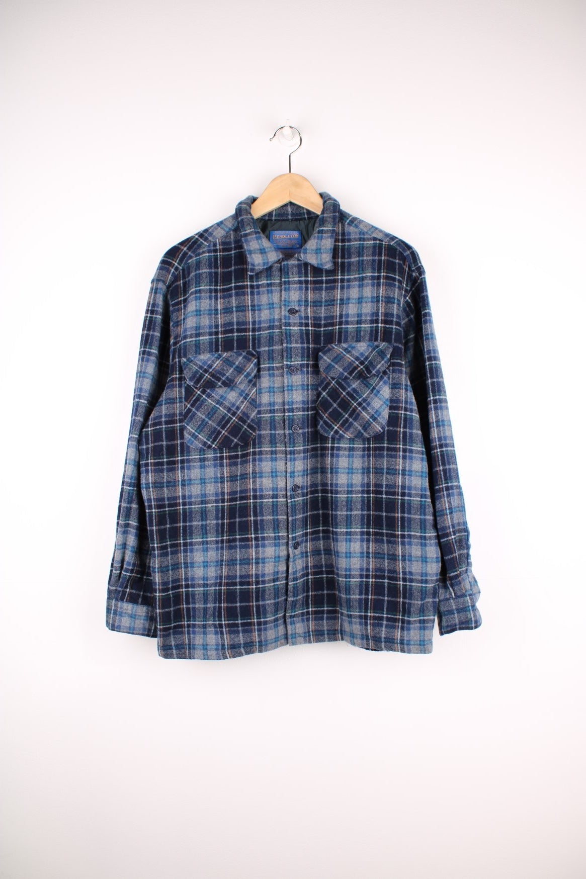 Blue plaid Pendleton shirt, 100% wool with two buttoned flap pockets.