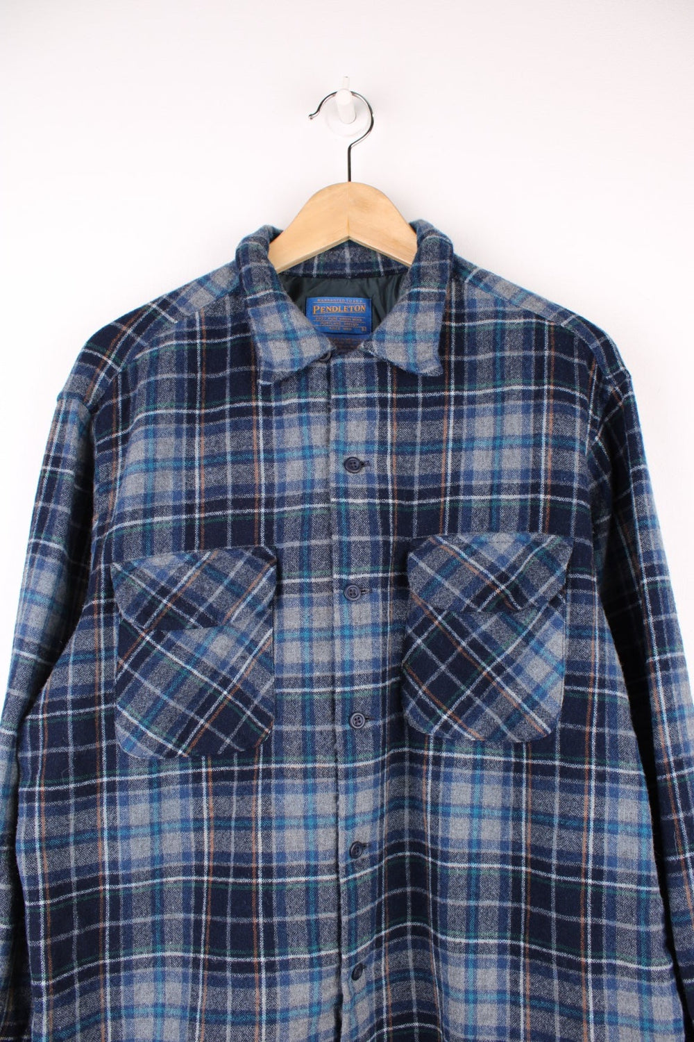 Blue plaid Pendleton shirt, 100% wool with two buttoned flap pockets.