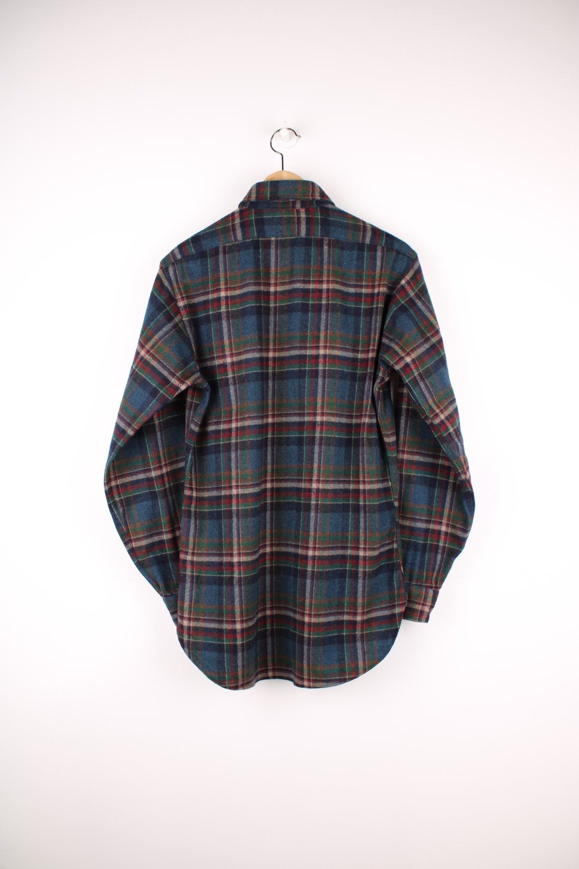 Dark blue, red and green plaid Pendleton shirt, 100% wool with one buttoned flap pocket.