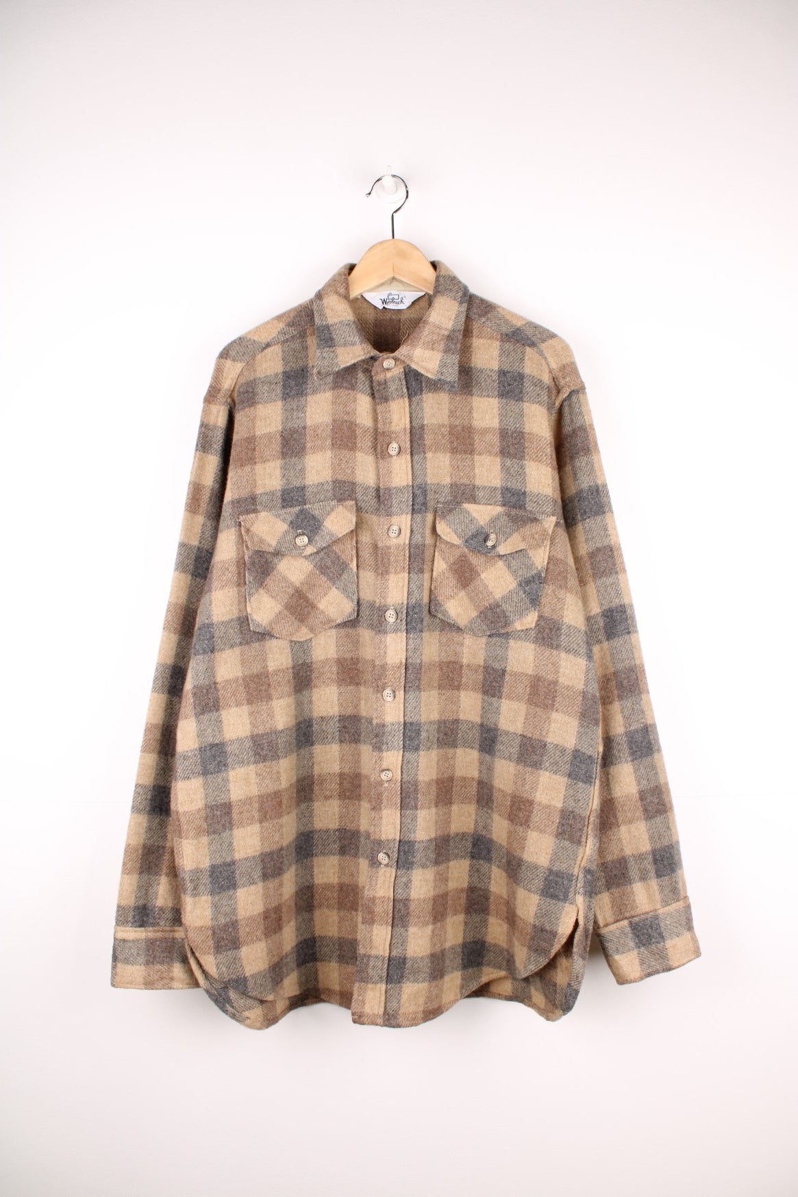 Woolrich tan and grey plaid wool shirt with two buttoned flap pockets. 