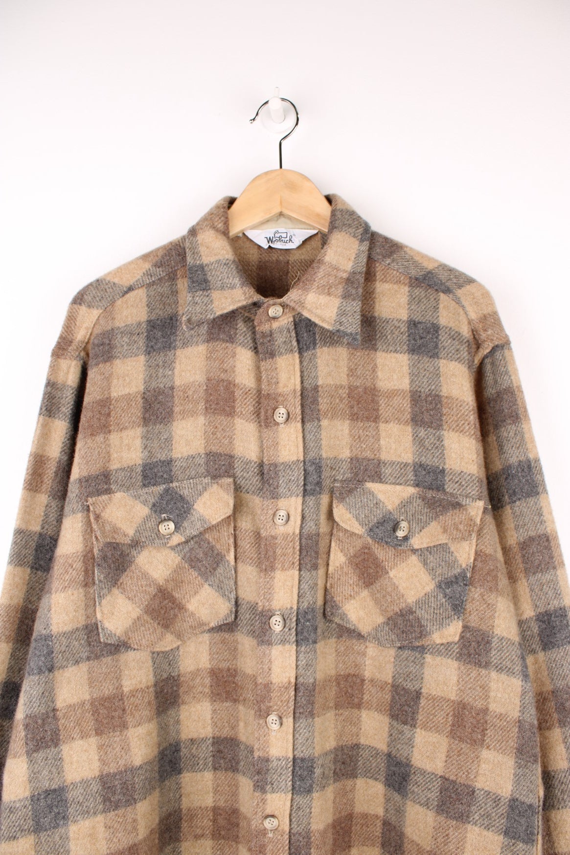 Woolrich tan and grey plaid wool shirt with two buttoned flap pockets. 