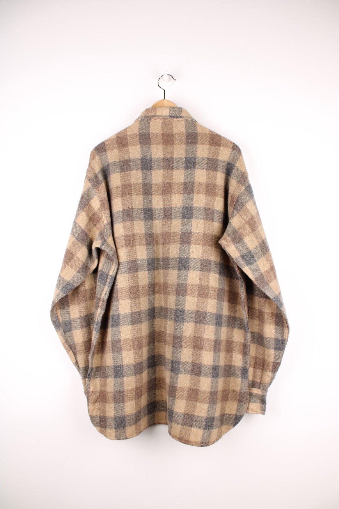 Woolrich tan and grey plaid wool shirt with two buttoned flap pockets. 