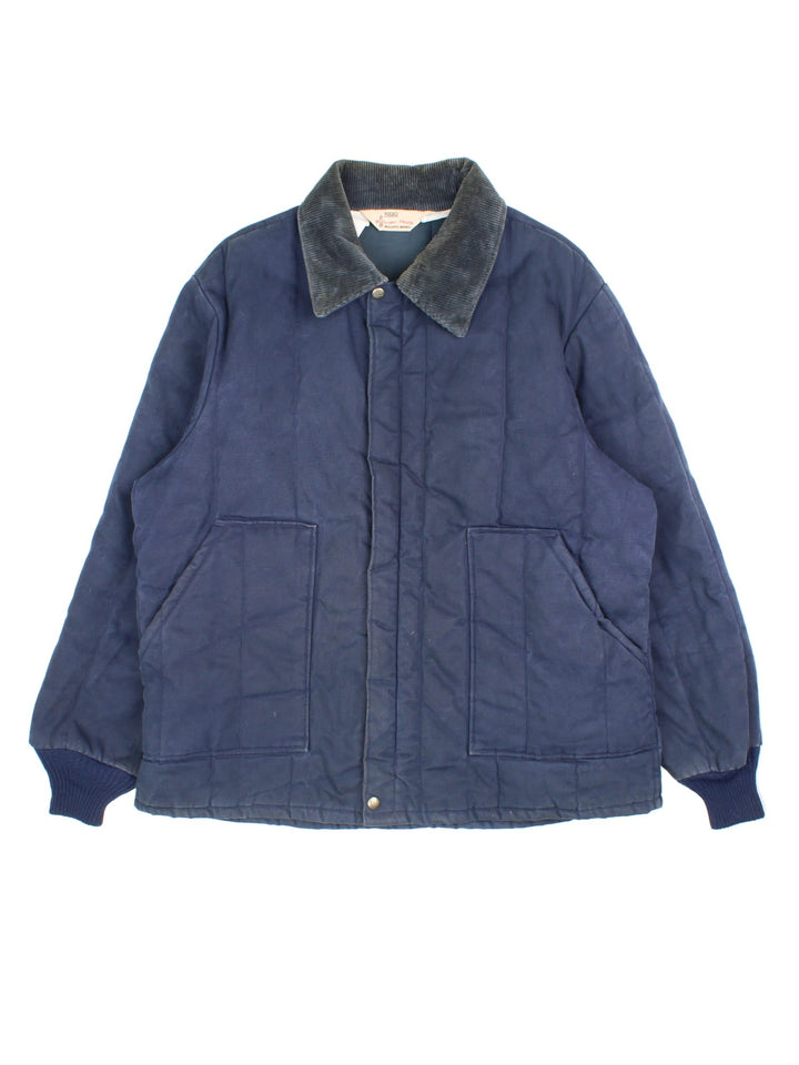 Vintage Walls Blizzard-Pruf Jacket in a navy blue colourway. Zips up and has side pockets, insulated with a quilted lining, and has a corduroy collar.