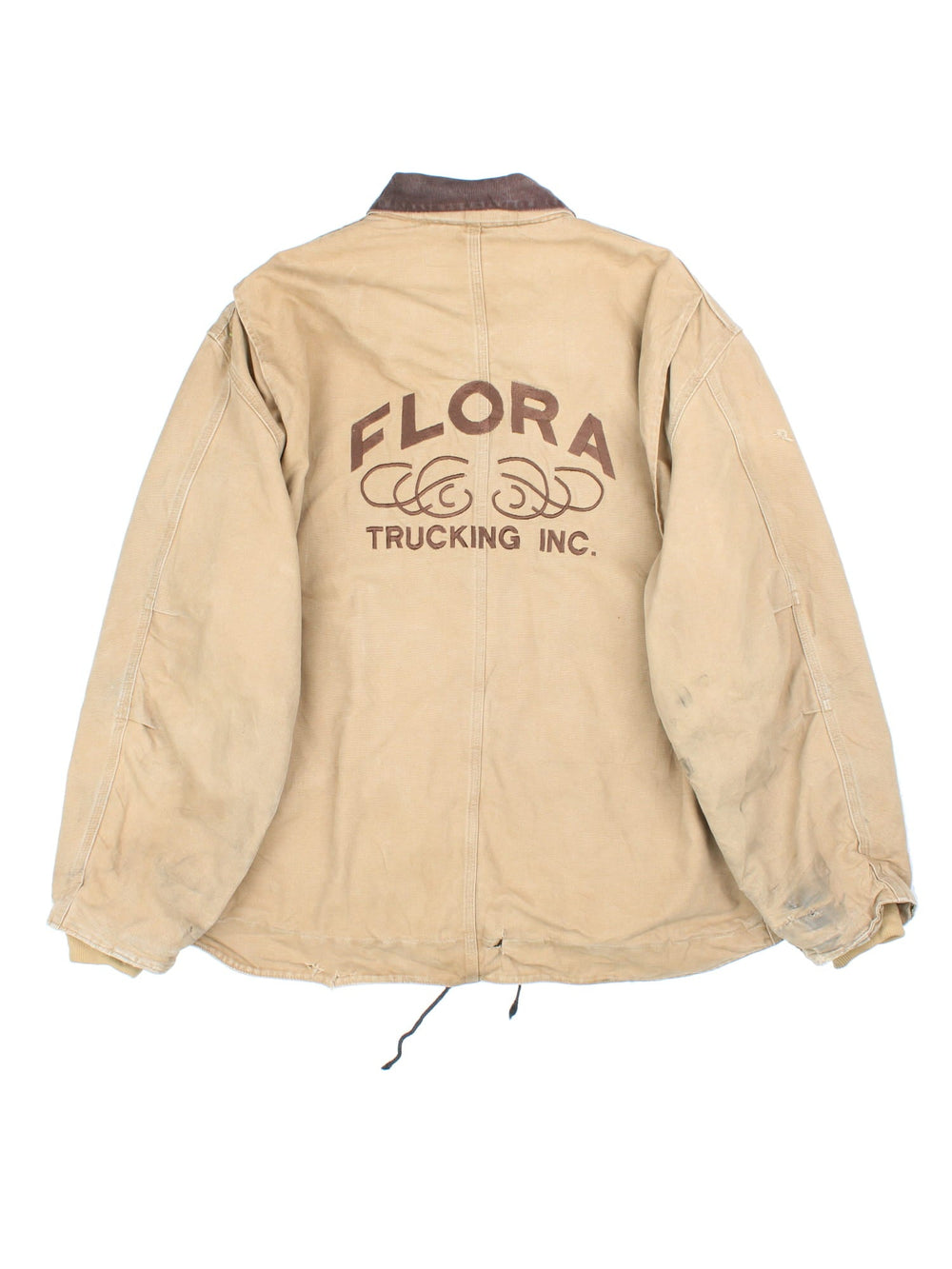 Vintage Carhartt Arctic Jacket in a tan colourway. Zips up and has multiple pockets, insulated with a sherpa lining, has the logo embroidered on the front, and 'Flora Trucking Inc' company logo / spell out embroidered on the back.