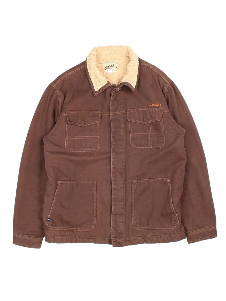 Vintage O'neill Sherpa Lined Jacket in a brown colourway. Buttons up and has multiple pockets, insulated with a sherpa lining, and has the logo embroidered on the front.