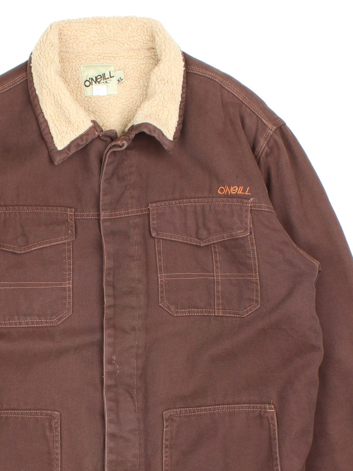 Vintage O'neill Sherpa Lined Jacket in a brown colourway. Buttons up and has multiple pockets, insulated with a sherpa lining, and has the logo embroidered on the front.