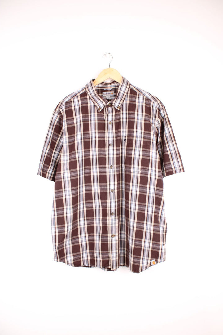 Carhartt Short Sleeve Shirt in a brown, white and blue plaid colourway, button up with a chest pocket, and has the logo embroidered on the front. 