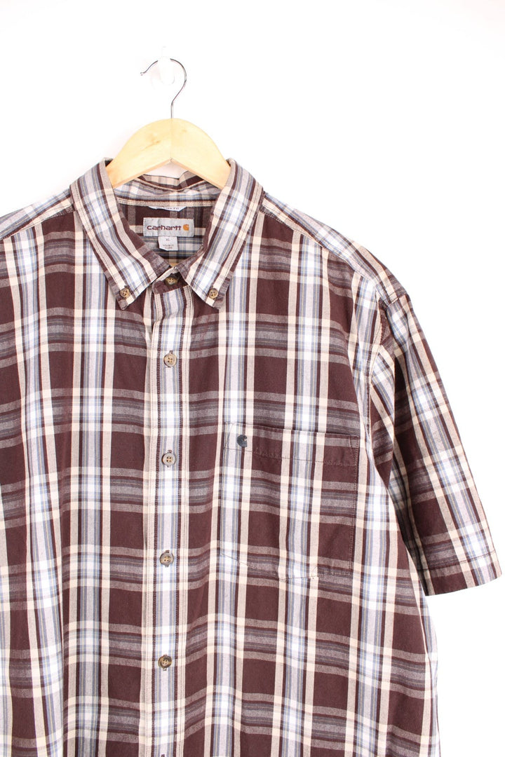 Carhartt Short Sleeve Shirt in a brown, white and blue plaid colourway, button up with a chest pocket, and has the logo embroidered on the front. 