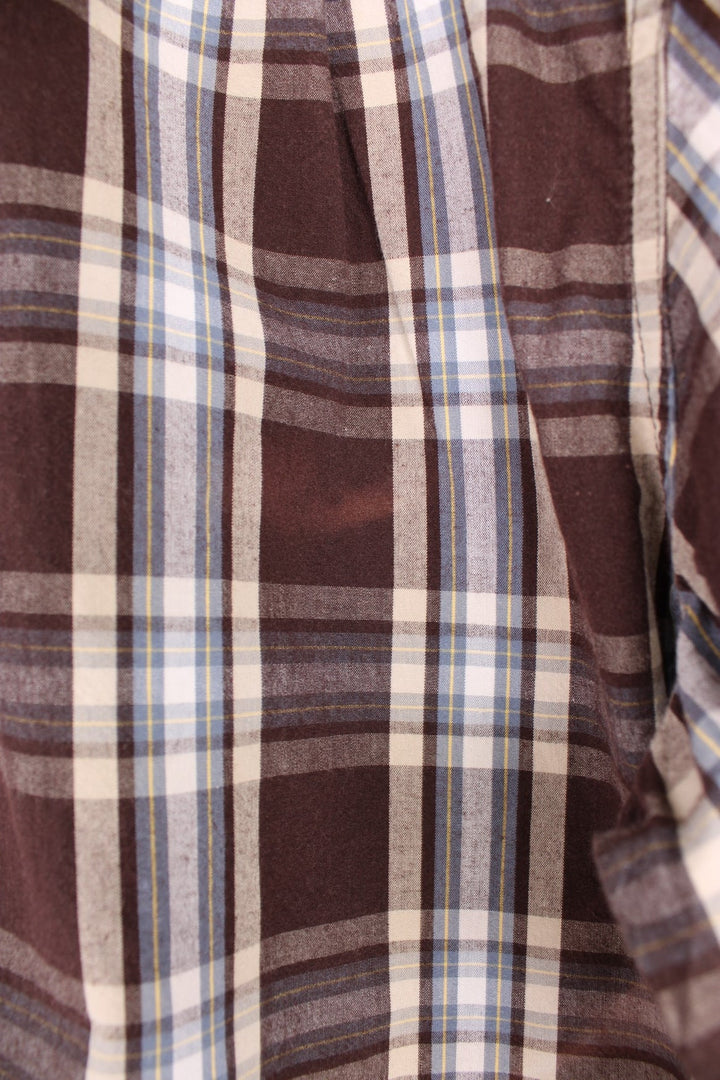 Carhartt Short Sleeve Shirt in a brown, white and blue plaid colourway, button up with a chest pocket, and has the logo embroidered on the front. 