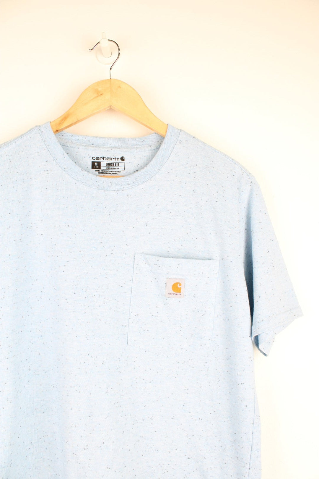 Carhartt T-Shirt in a blue and black colourway, dotted pattern throughout, and has a chest pocket with the logo embroidered on the front.