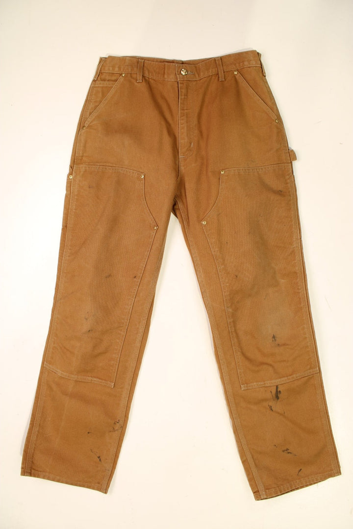 Carhartt Double Knee Jeans in a brown colourway with multiple pockets and the logo embroidered on the back.