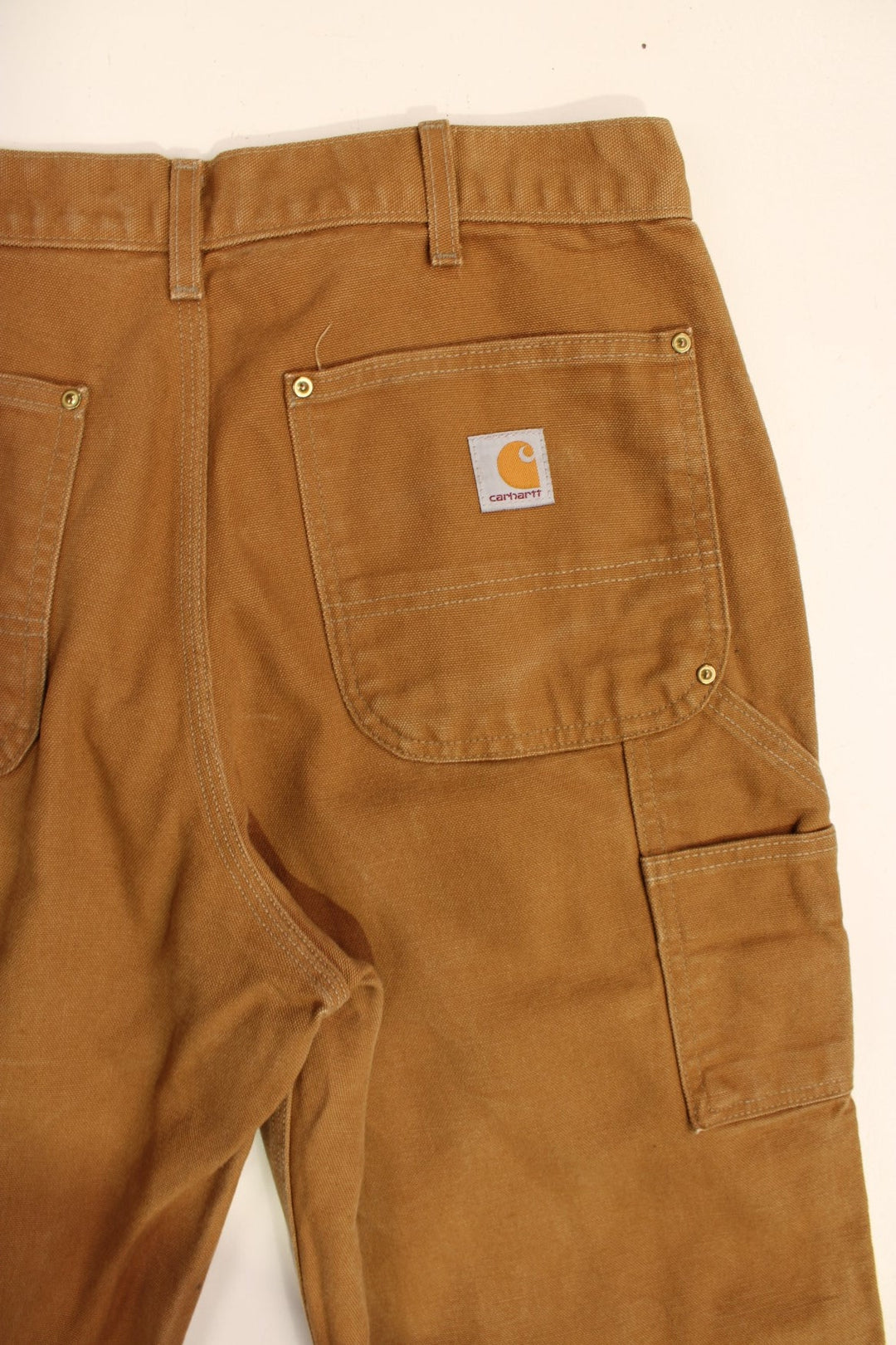 Carhartt Double Knee Jeans in a brown colourway with multiple pockets and the logo embroidered on the back.