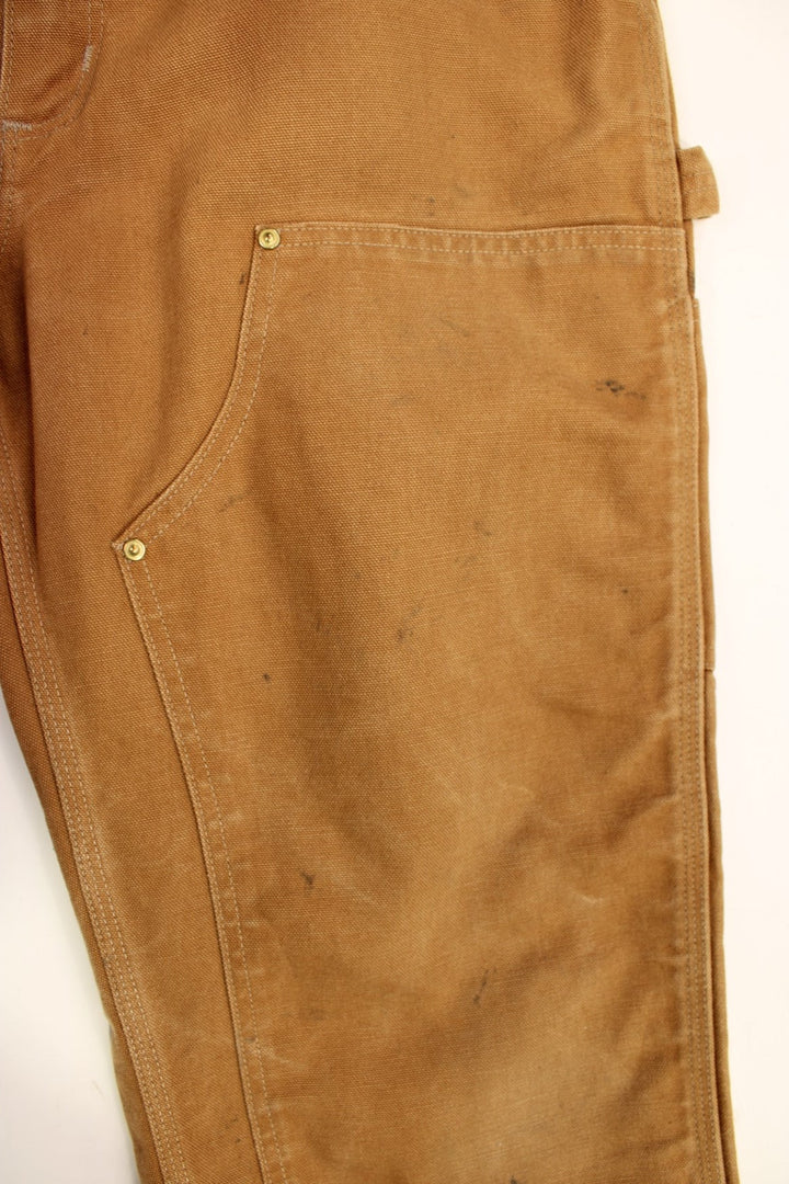 Carhartt Double Knee Jeans in a brown colourway with multiple pockets and the logo embroidered on the back.