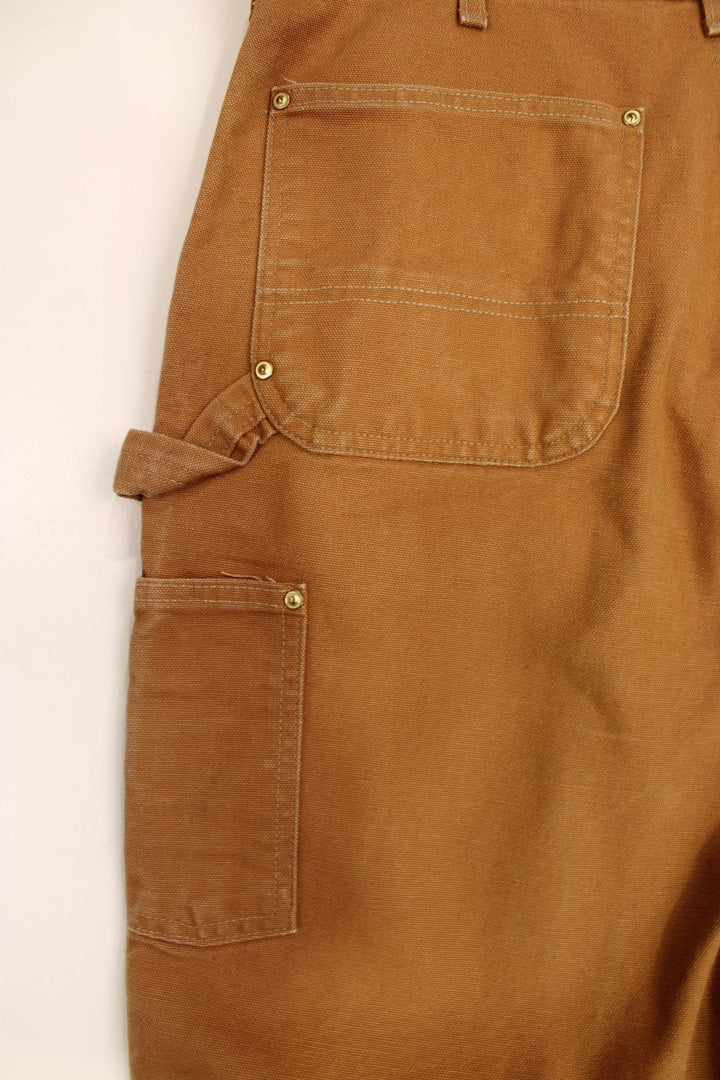 Carhartt Double Knee Jeans in a brown colourway with multiple pockets and the logo embroidered on the back.